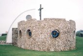 Looks like a ship, or a Martello Tower. This is the eastern apse. Inside is open to the air, and there is a rough altar.