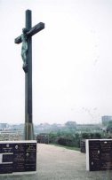 This cross originally adorned a gothic Calvaire, but it was destroyed by either German or British bombing. Only the cross survived.